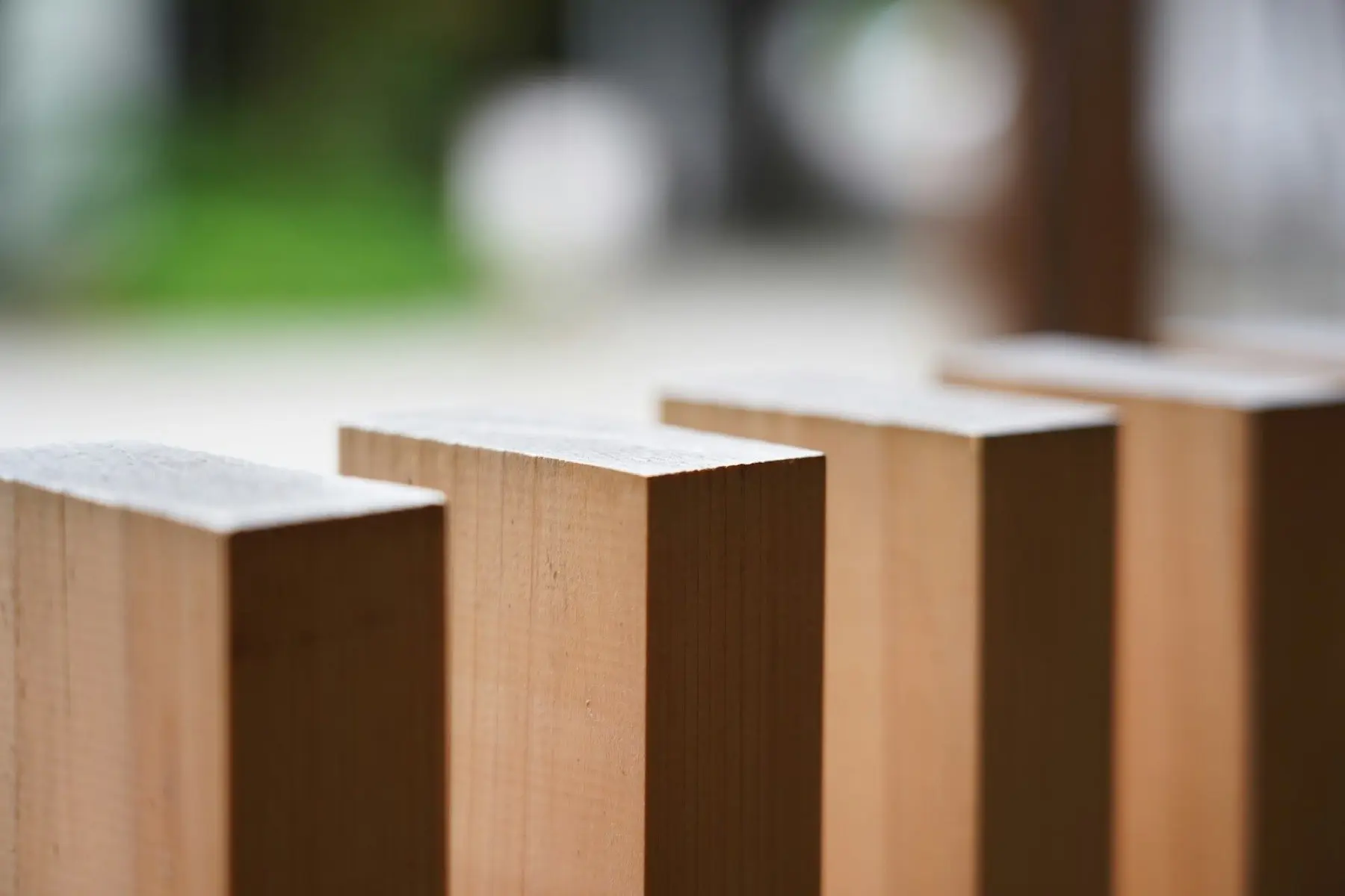 Close-up of square wooden fence post tops
